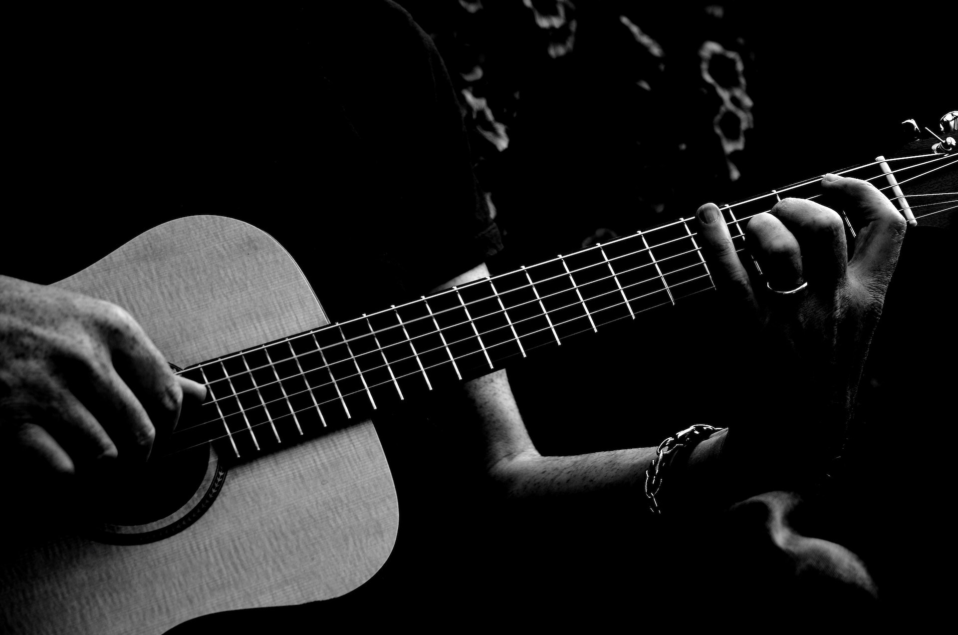Person Playing Acoustic Guitar